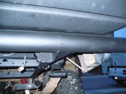 1979 Ford Bronco - Close-up view of the undercarriage, revealing suspension and exhaust systems.