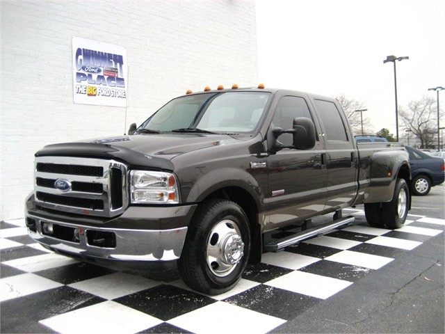 Dark brown dually pickup truck parked on checkered floor