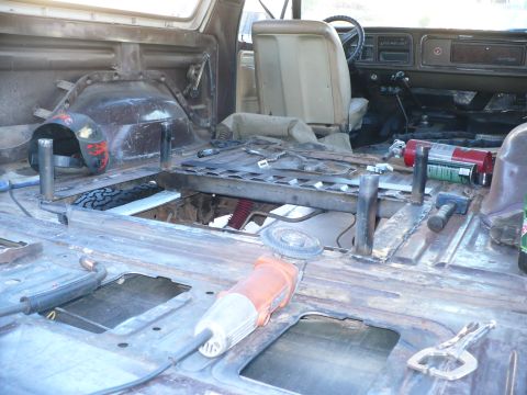 1979 Ford Bronco - Interior of a 1979 Ford Bronco being worked on, with tools and parts visible.