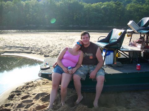1979 Ford F-250 - Couple relaxing on a boat dock next to a river on a sunny day.