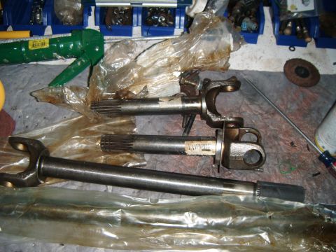 1994 Ford Bronco - Two driveshaft components are laid out, one with a partial label visible. The image appears to be taken in a workshop setting.