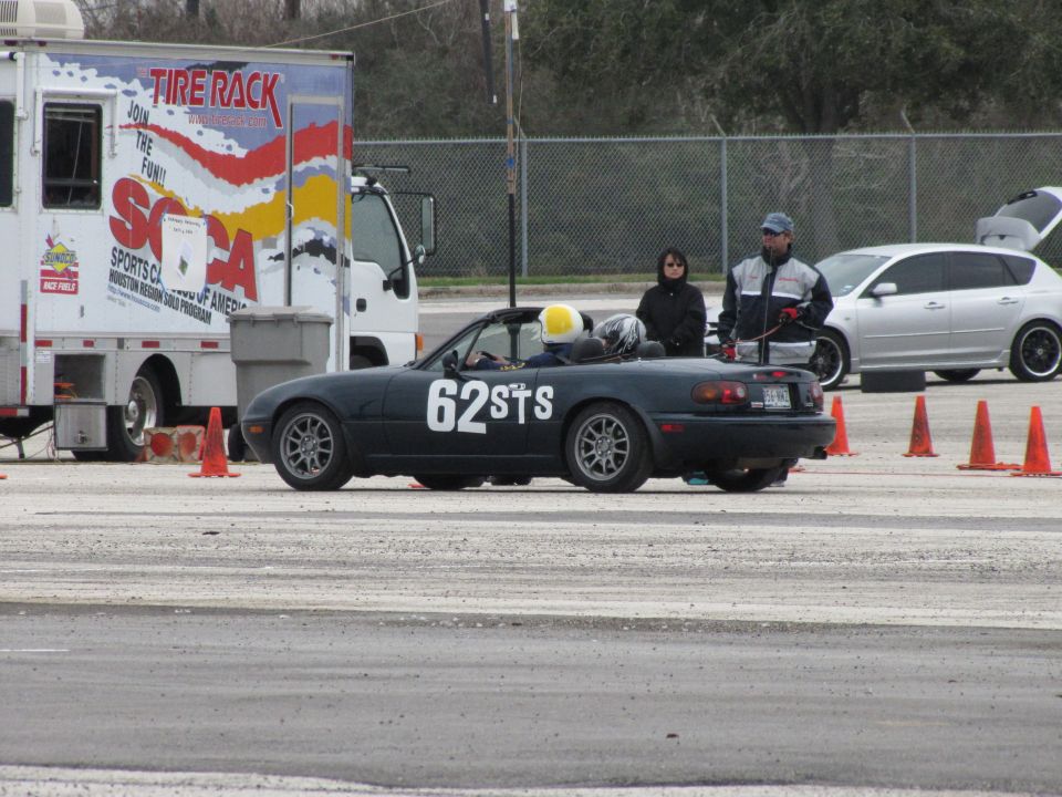 Dark blue convertible with racing numbers 62STS on the side, seen from the side