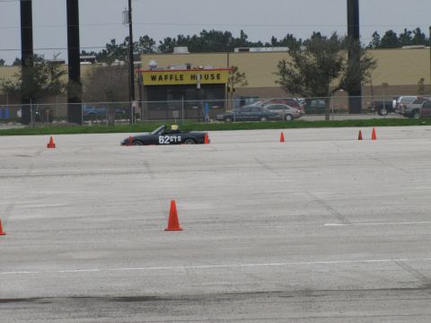 2003 Mazda Protege - Convertible with racing numbers on a paved lot, with a Waffle House in the background.