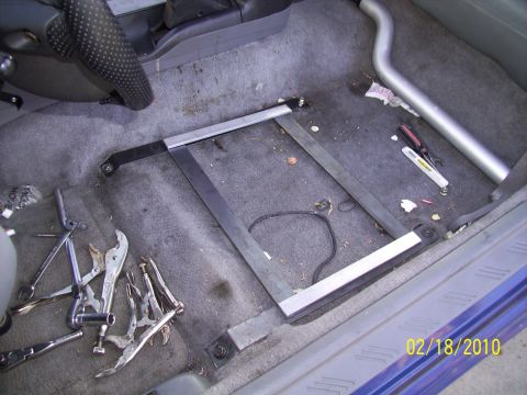 1995 Ford Probe - Tools and a metal frame are on the floor of a car's interior, with a date stamp of 02/18/2010.