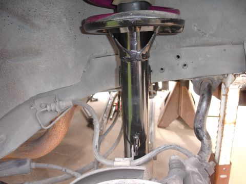 1995 Ford Taurus - Suspension strut and brake components visible in a vehicle's wheel well.