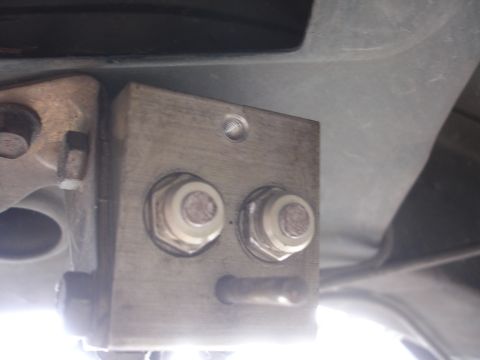 1995 Ford Taurus - This image shows a close-up of an automotive part with visible bolts and mounting hardware.