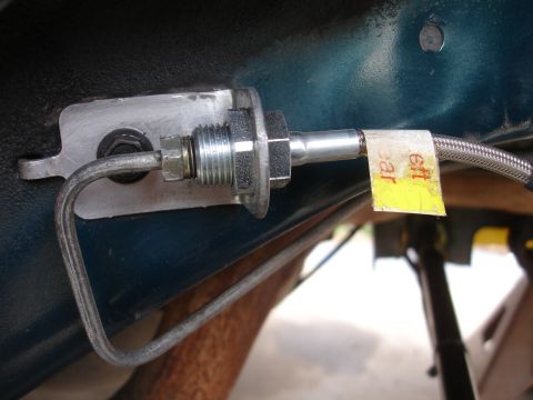 1995 Ford Taurus - Close-up of a brake line with a yellow tag indicating 'left rear'.