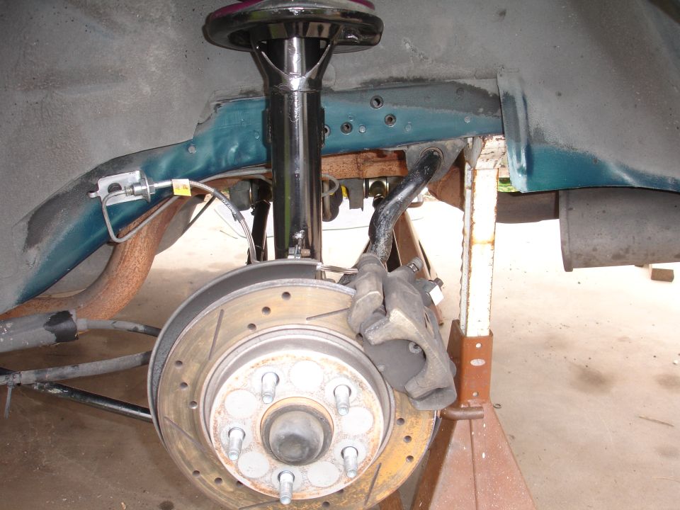 Car suspension with a vented rotor and caliper, supported by a jack stand