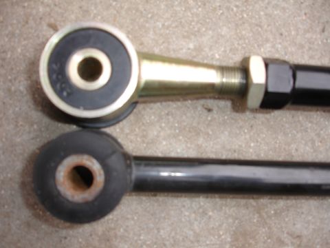 1995 Ford Taurus - Comparison of two suspension links, highlighting differences in material finish and bushing condition.