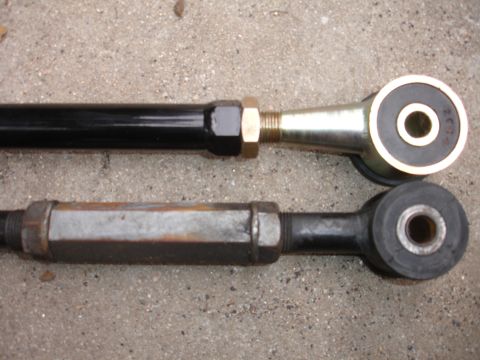 1995 Ford Taurus - Comparison of two different automotive suspension rods, one appearing new and the other showing signs of wear and rust.