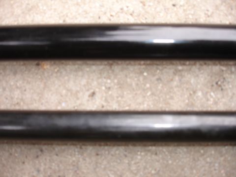 1995 Ford Taurus - Two black metal bars are shown against a concrete background.