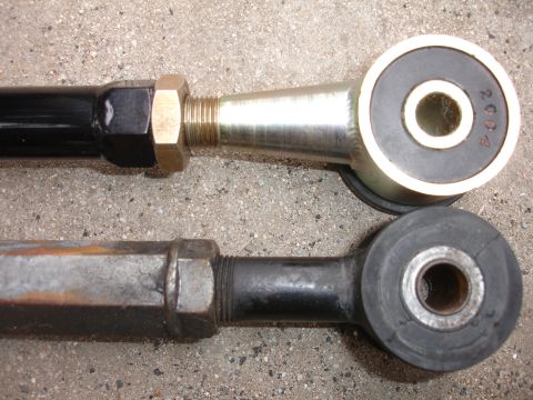1995 Ford Taurus - Comparison of a new suspension control arm next to an older, rusted one.