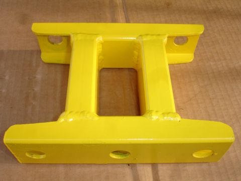1995 Ford Taurus - This yellow metal part appears to be an automotive component, possibly a brace or mount.