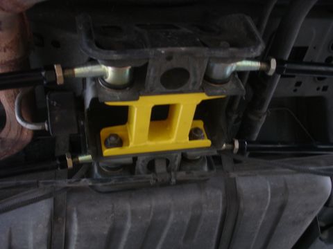 1995 Ford Taurus - Aftermarket rear suspension brace installed on a vehicle's undercarriage.
