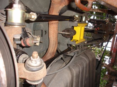 1995 Ford Taurus - Close-up view of aftermarket suspension components installed on a vehicle's undercarriage.