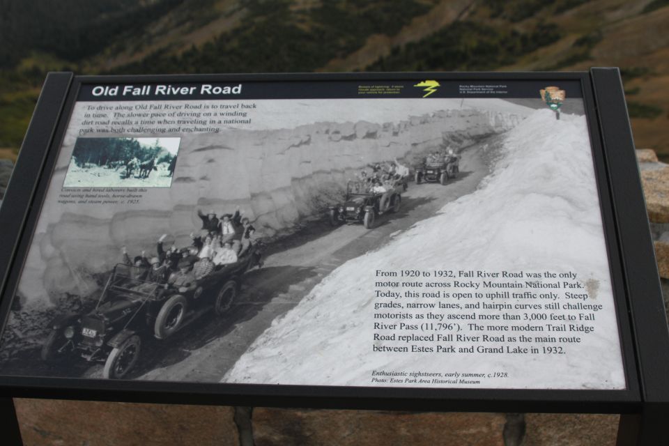 Roadside interpretive sign titled Old Fall River Road with vintage touring-car photo