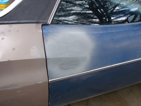 1973 Ford Ranchero - Side view of a car door showing mismatched paint and repair work.