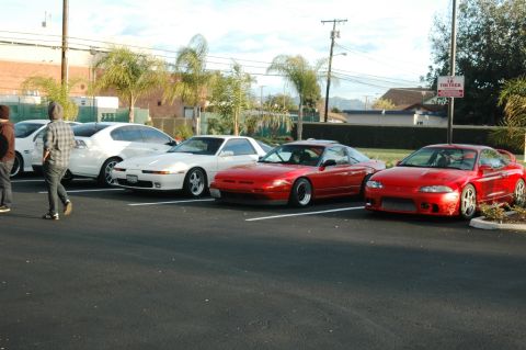2006 Cadillac STS - A group of sports cars are parked in a lot on a sunny day.