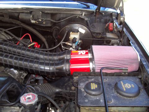 1994 Ford Bronco - Close-up of the engine bay showing a K&N air filter and dual intake tubes.