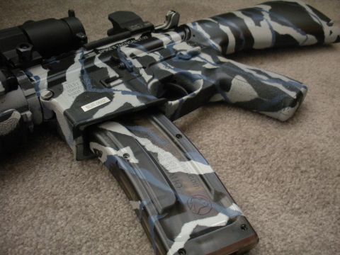 1996 Ford Bronco - An assault rifle is shown with a distinctive camouflage paint job covering its body and magazine.