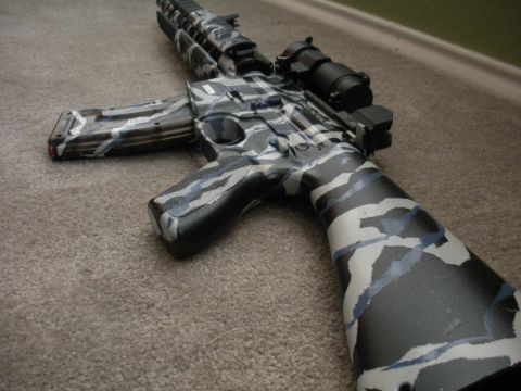 1996 Ford Bronco - This assault rifle features a unique camouflage paint scheme with black, white, and blue patterns.