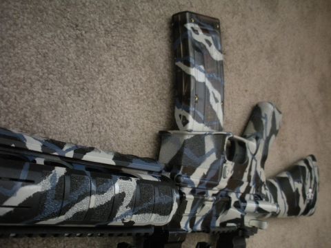 1996 Ford Bronco - Rifle receiver and magazine with a blue, black, and white camouflage paint job.
