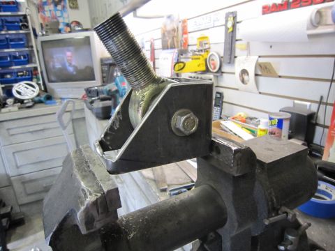 1996 Ford Bronco - Custom metal bracket with threaded rod held in a vise, likely for fabrication or repair.