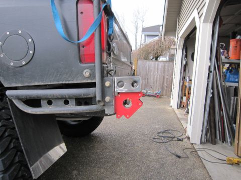 1996 Ford Bronco - The rear of a 1996 Ford Bronco shows a custom red tow hitch attachment and a mud flap.