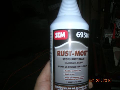 1985 Ford Bronco - A bottle of SEM Rust-Mort is held in a hand, with the product label clearly visible.