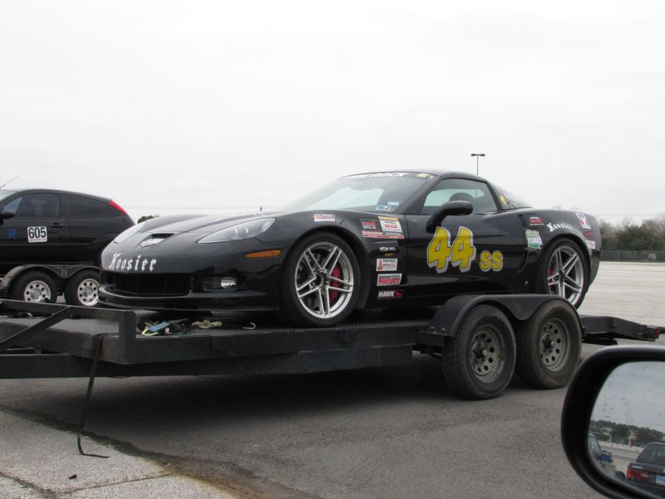 Black Chevrolet Corvette with racing decals and number 44 SS on a trailer