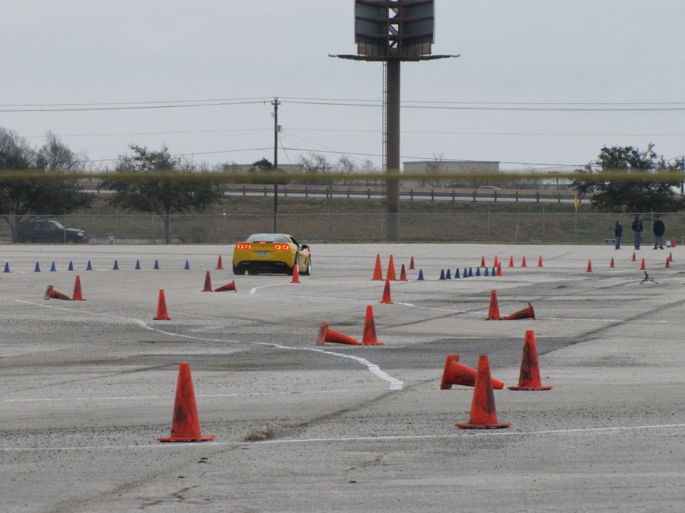 Yellow sports car on a race track with cones