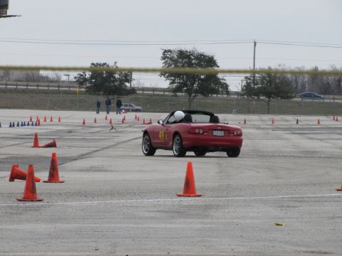 2003 Mazda Protege - Red convertible sports car with number 49 on the door, navigating a course marked by orange cones.
