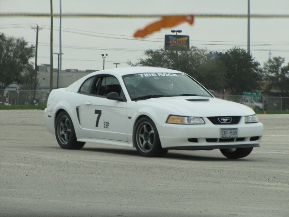 White Ford Mustang with number 7 and ESP on the door, driving on a track