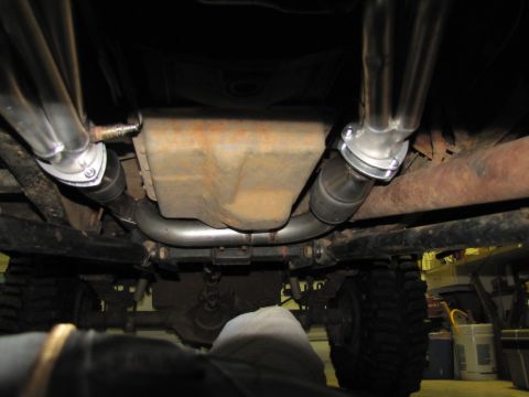 1995 Ford Bronco - Undercarriage view shows the exhaust system and transmission pan of a vehicle.