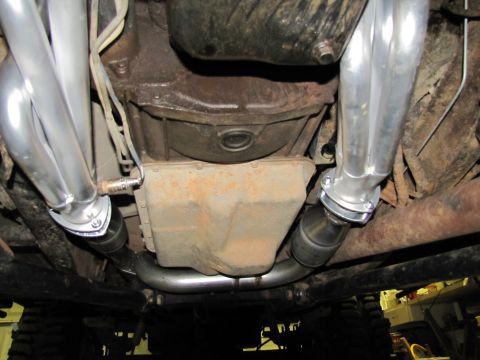 1995 Ford Bronco - Underside view of engine components, including exhaust headers and oil pan.