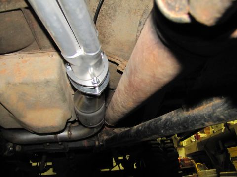1995 Ford Bronco - The underside of a vehicle, focusing on the exhaust system and transmission with a Ford logo.