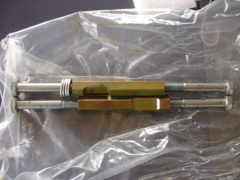 1995 Ford Taurus - Adjustable suspension components are shown inside plastic packaging, with bolts and washers visible.