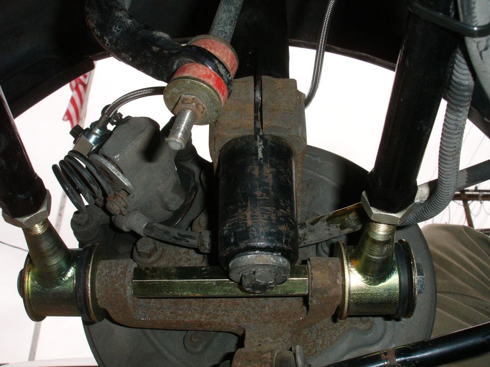 close-up of car's rear suspension with yellow and red parts