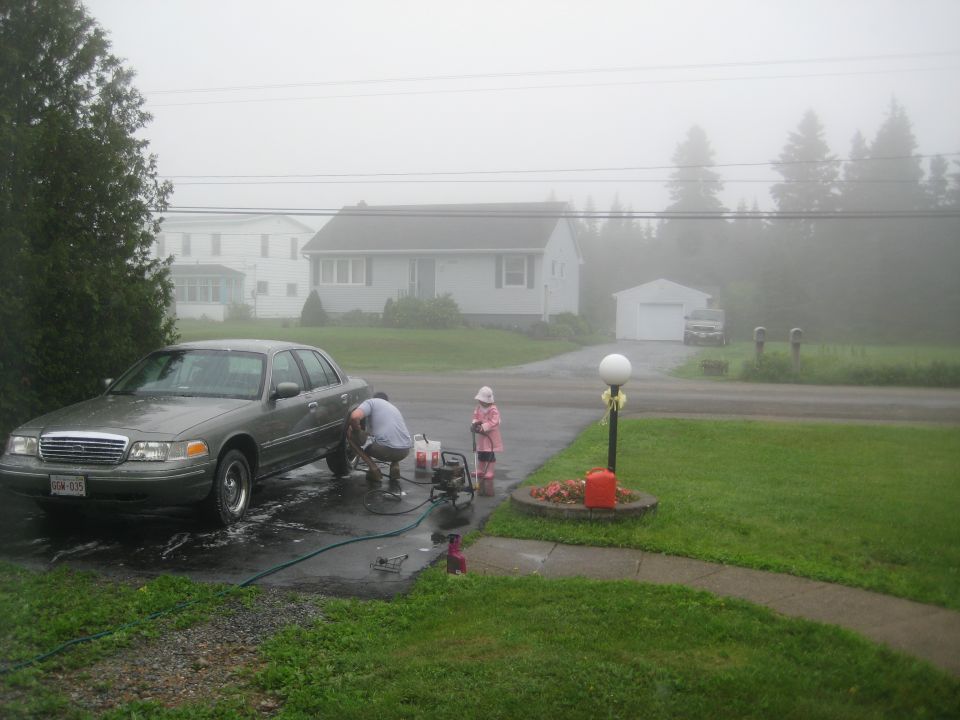 Gray 1999 Ford Crown Victoria being washed in driveway