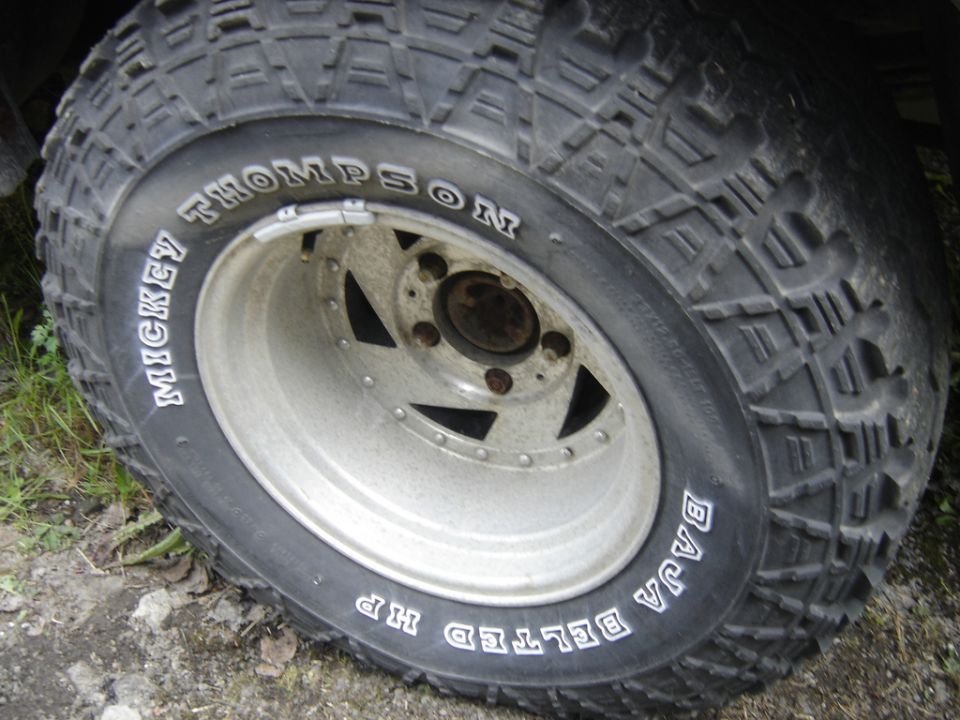 Close-up of a Mickey Thompson Baja Belted tire on a silver wheel