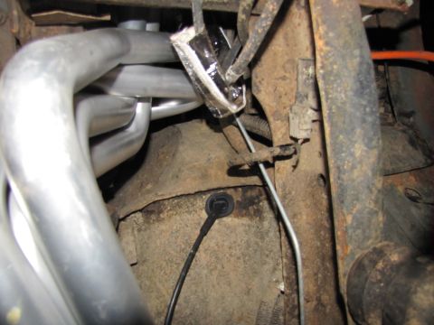 1995 Ford Bronco - Engine bay detail showing exhaust manifold and various wires and brackets.
