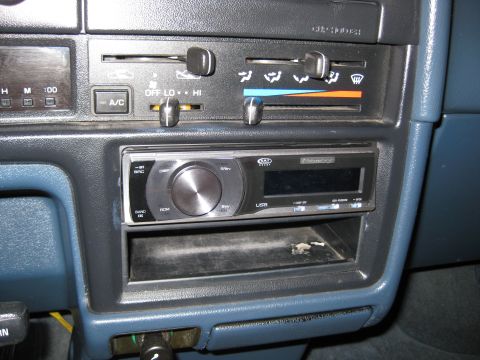 1990 Toyota Pickup/SR5 - Close-up of a car's dashboard, focusing on the climate controls and aftermarket stereo system.