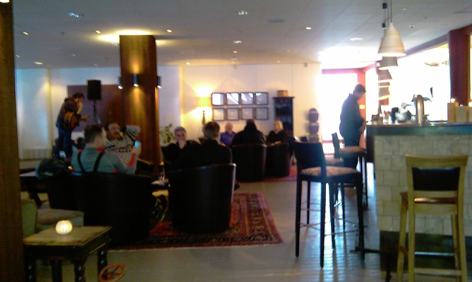People relaxing in a modern hotel lounge with a bar