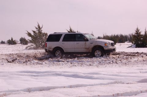 2002 Ford Expedition - This 2002 Ford Expedition is struggling to gain traction in the snowy, muddy terrain.