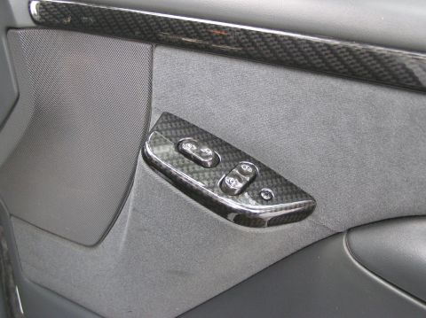 1993 Ford Bronco - The interior door panel features carbon fiber accents around the power window switches and trim.