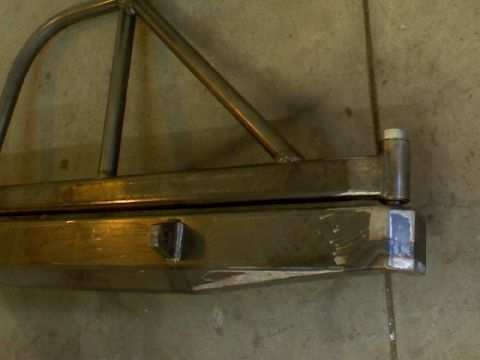 1993 Ford Bronco - Custom rear bumper and roll cage tubing shown close-up against a concrete floor.