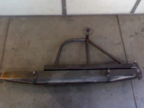 1993 Ford Bronco - This is a custom fabricated rear bumper with an integrated tire carrier mount, shown on a concrete floor.