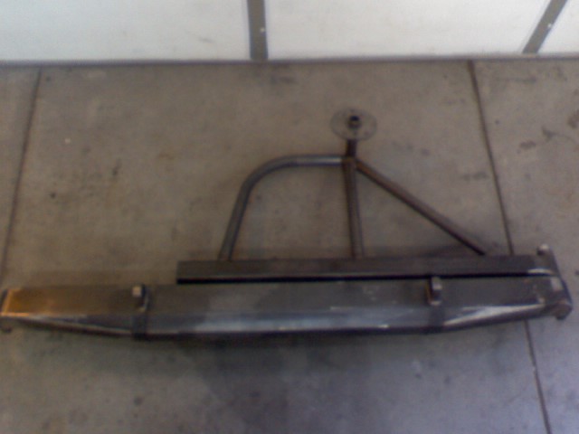 Custom rear bumper with a swing-away tire carrier mount