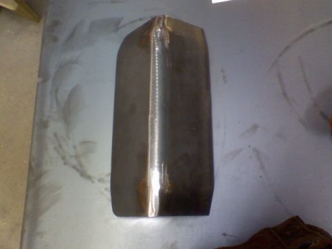 1993 Ford Bronco - An unfinished metal component with a prominent weld line is shown, likely a replacement part for a vehicle.