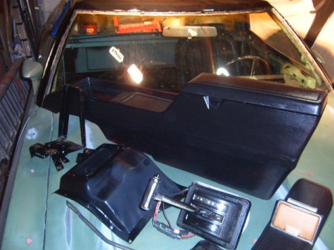 1973 Ford Ranchero - Disassembled interior components of a 1973 Ford Ranchero are laid out on the exterior of the vehicle.